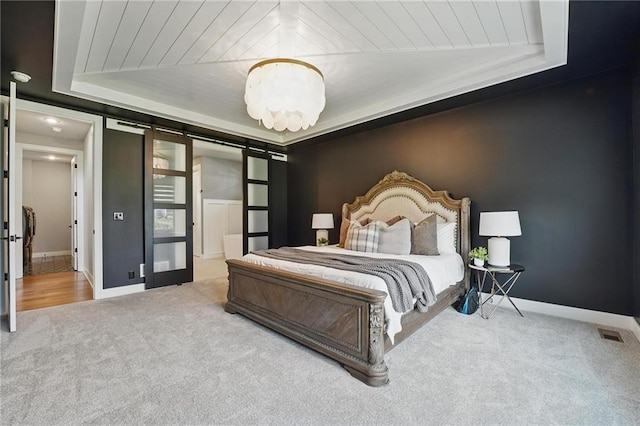 17137 Barton St, Overland Park, KS 66221 - bedroom with a barn door, carpet flooring, baseboards, and wooden ceiling