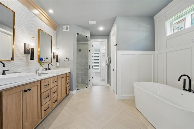 17137 Barton St, Overland Park, KS 66221 - full bathroom featuring a shower stall, double vanity, a freestanding bath, and recessed lighting