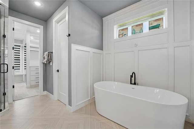 17137 Barton St, Overland Park, KS 66221 - bathroom with a decorative wall, a freestanding bath, a shower stall, and recessed lighting