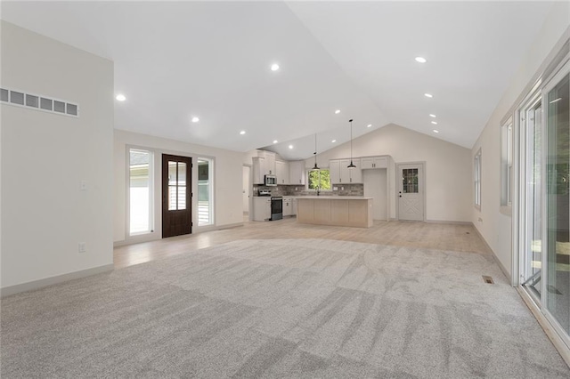 38 NW 525th Rd, Warrensburg, MO 64093 - unfurnished living room with vaulted ceiling, light carpet, and recessed lighting