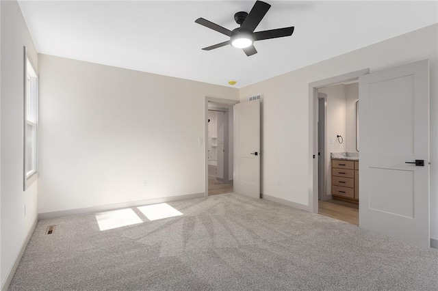 38 NW 525th Rd, Warrensburg, MO 64093 - unfurnished bedroom with light colored carpet, connected bathroom, and a ceiling fan
