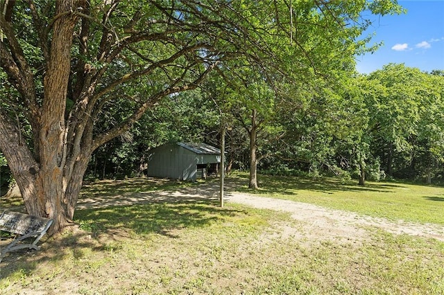 38 NW 525th Rd, Warrensburg, MO 64093 - view of green lawn with a pole building, an outbuilding, and a forest view
