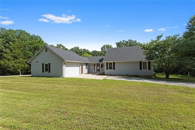 38 NW 525th Rd, Warrensburg, MO 64093 - ranch-style house with an attached garage, concrete driveway, and a front yard