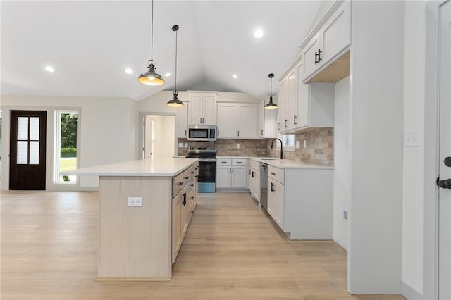38 NW 525th Rd, Warrensburg, MO 64093 - kitchen featuring appliances with stainless steel finishes, lofted ceiling, light countertops, decorative backsplash, and light wood finished floors