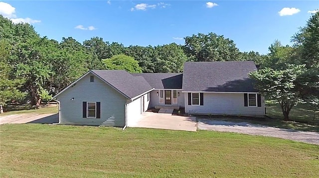 38 NW 525th Rd, Warrensburg, MO 64093 - rear view of house with a garage, a lawn, and concrete driveway