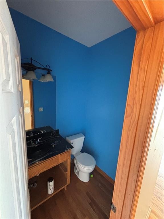 952 NW Maplewood Ct, Grain Valley, MO 64029 - half bath with wood finished floors, vanity, and toilet