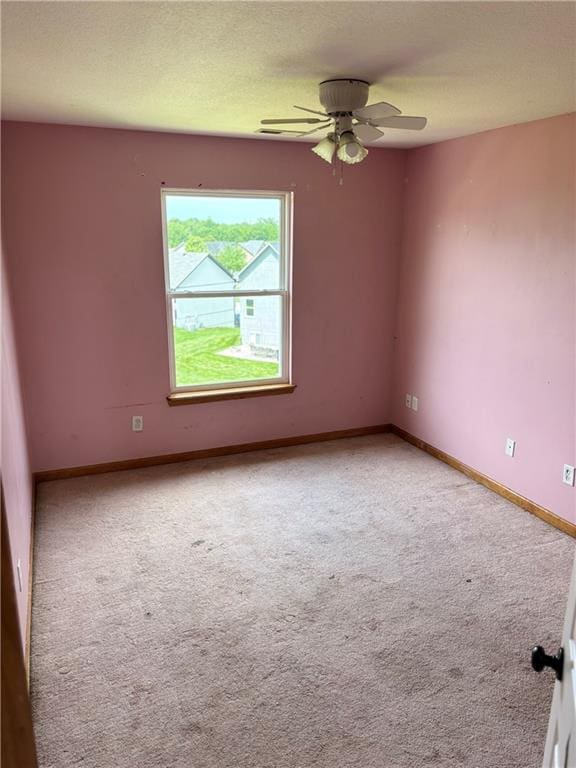 952 NW Maplewood Ct, Grain Valley, MO 64029 - carpeted empty room with ceiling fan, baseboards, and a textured ceiling