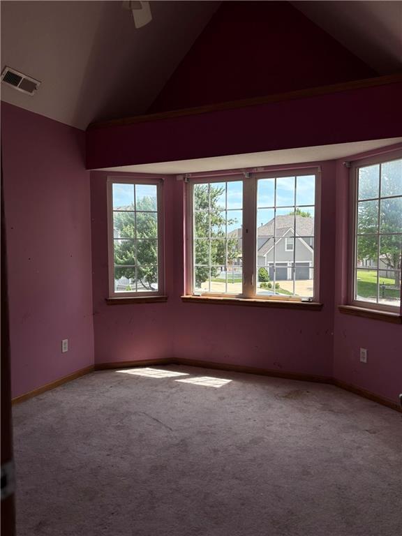 952 NW Maplewood Ct, Grain Valley, MO 64029 - carpeted spare room with vaulted ceiling, plenty of natural light, and baseboards