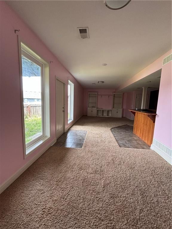 952 NW Maplewood Ct, Grain Valley, MO 64029 - unfurnished living room featuring light carpet and baseboards