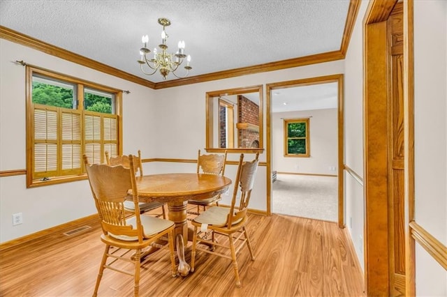 4506 NW Apache Dr, Riverside, MO 64150 - dining area with a chandelier, light wood-style flooring, a textured ceiling, crown molding, and healthy amount of natural light