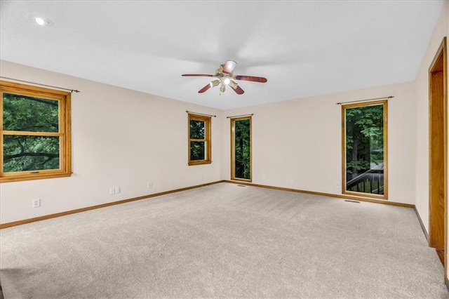 4506 NW Apache Dr, Riverside, MO 64150 - carpeted spare room featuring baseboards, healthy amount of natural light, and ceiling fan