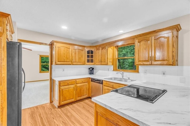 4506 NW Apache Dr, Riverside, MO 64150 - kitchen with freestanding refrigerator, stainless steel dishwasher, light wood-style flooring, a sink, and light countertops