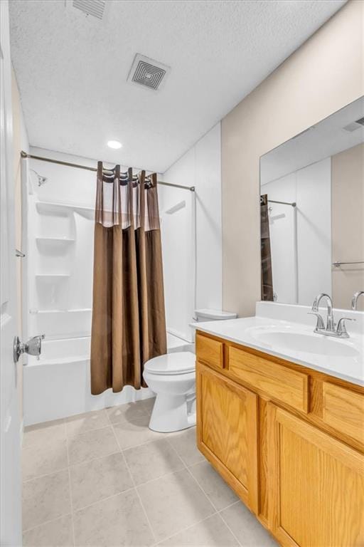 4506 NW Apache Dr, Riverside, MO 64150 - full bathroom with vanity, shower / bath combo with shower curtain, toilet, tile patterned floors, and a textured ceiling