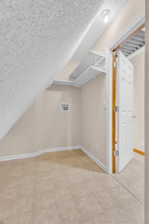 4506 NW Apache Dr, Riverside, MO 64150 - laundry room featuring a textured ceiling, washer hookup, baseboards, and tile patterned flooring