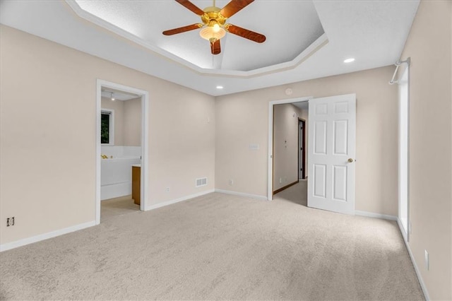 4506 NW Apache Dr, Riverside, MO 64150 - unfurnished bedroom with light colored carpet, a tray ceiling, baseboards, and recessed lighting