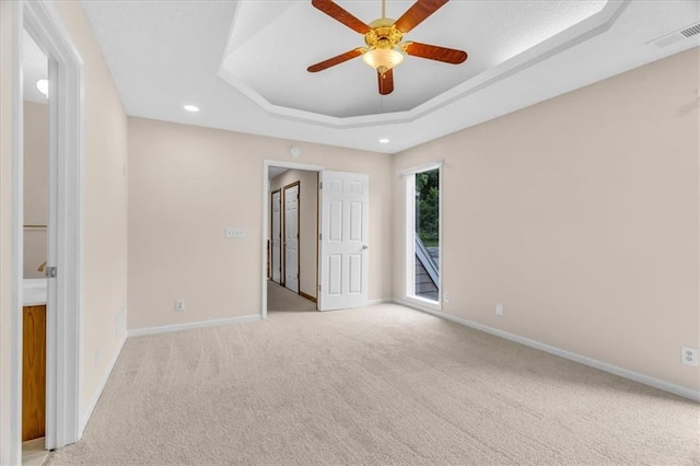 4506 NW Apache Dr, Riverside, MO 64150 - unfurnished bedroom featuring light carpet, baseboards, access to exterior, a tray ceiling, and recessed lighting
