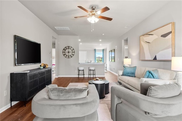 37838 W 208th Ter, Edgerton, KS 66021 - living room featuring wood finished floors, ceiling fan, and baseboards