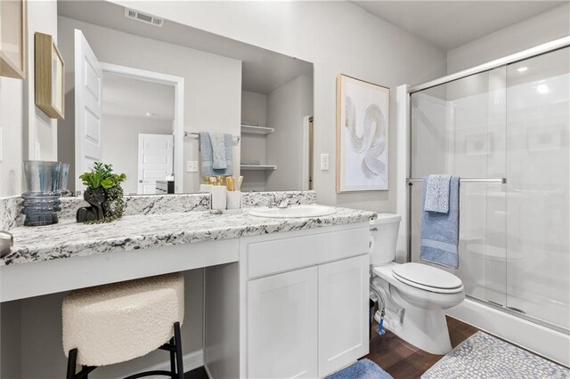 37838 W 208th Ter, Edgerton, KS 66021 - full bathroom with vanity, wood finished floors, a shower stall, and toilet