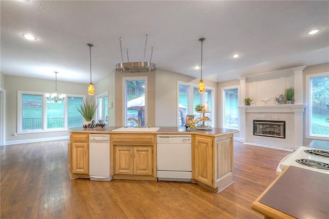 5706 NE Sapphire Pl, Lees Summit, MO 64064 - kitchen featuring white appliances, a sink, light wood-type flooring, a fireplace with flush hearth, and a chandelier