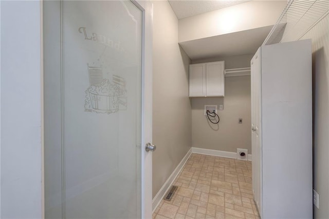 5706 NE Sapphire Pl, Lees Summit, MO 64064 - laundry area with cabinet space, hookup for a washing machine, hookup for an electric dryer, baseboards, and brick patterned flooring