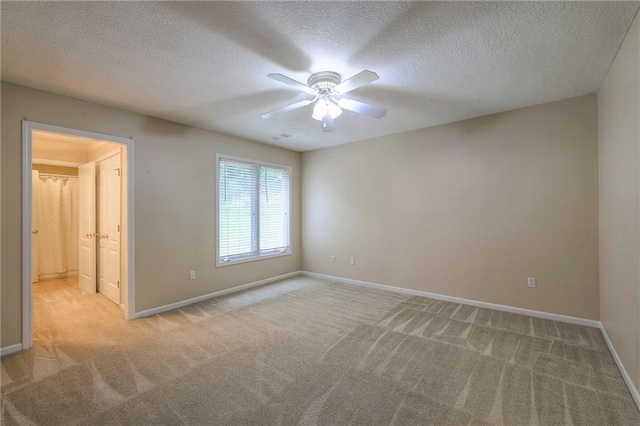 5706 NE Sapphire Pl, Lees Summit, MO 64064 - spare room featuring light colored carpet, ceiling fan, baseboards, and a textured ceiling