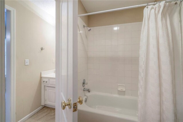 5706 NE Sapphire Pl, Lees Summit, MO 64064 - bathroom featuring shower / bath combination with curtain, vanity, and baseboards