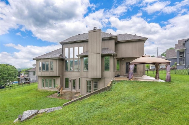 5706 NE Sapphire Pl, Lees Summit, MO 64064 - back of house featuring a gazebo, a patio, roof with shingles, and a chimney
