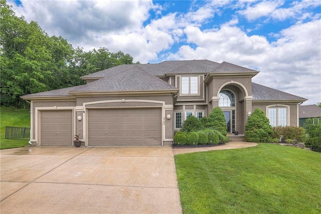 5706 NE Sapphire Pl, Lees Summit, MO 64064 - view of front facade featuring a front lawn, a garage, concrete driveway, a shingled roof, and stucco siding