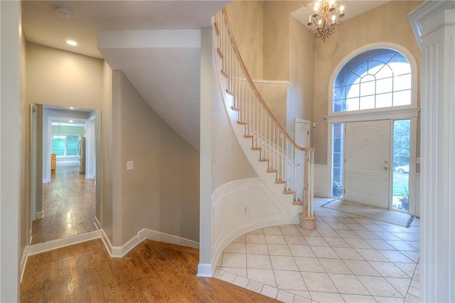 5706 NE Sapphire Pl, Lees Summit, MO 64064 - entrance foyer featuring a high ceiling, stairs, a chandelier, light wood-style floors, and recessed lighting