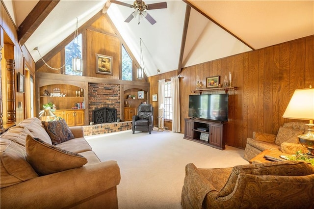 401 E 129th Ter, Kansas City, MO 64145 - living room featuring wood walls, high vaulted ceiling, a fireplace, beamed ceiling, and ceiling fan