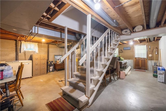 401 E 129th Ter, Kansas City, MO 64145 - basement featuring stairway, fridge, and healthy amount of natural light