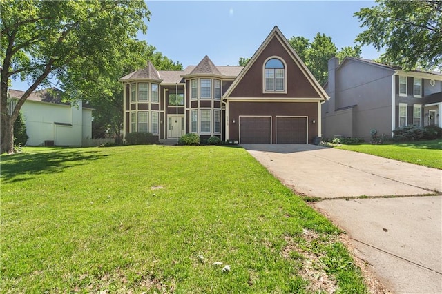11415 Oakview Dr, Lenexa, KS 66215 - view of front of house featuring an attached garage, concrete driveway, a front yard, and stucco siding
