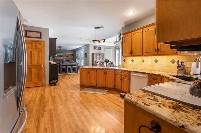11415 Oakview Dr, Lenexa, KS 66215 - kitchen featuring white appliances, a peninsula, a ceiling fan, light wood-style floors, and backsplash