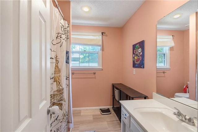 11415 Oakview Dr, Lenexa, KS 66215 - bathroom with vanity, toilet, baseboards, a textured ceiling, and curtained shower