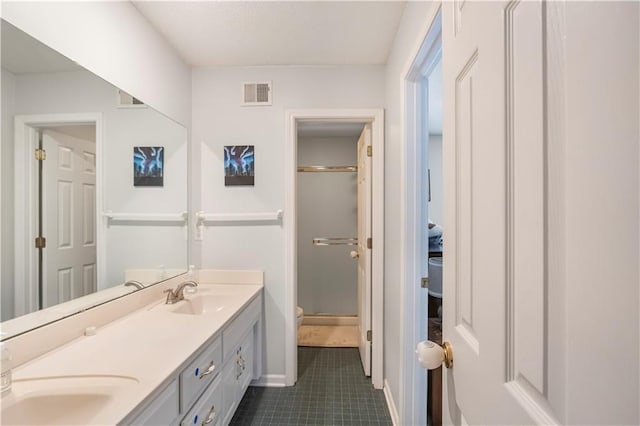 11415 Oakview Dr, Lenexa, KS 66215 - bathroom featuring tile patterned flooring, double vanity, a stall shower, toilet, and baseboards