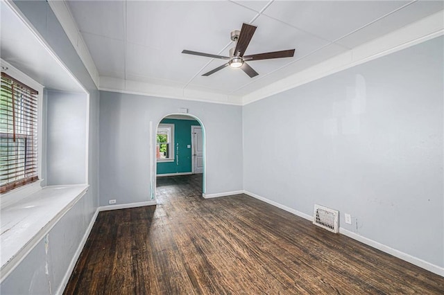 1409 N 24th St, Kansas City, KS 66102 - spare room featuring ceiling fan, arched walkways, wood finished floors, and baseboards