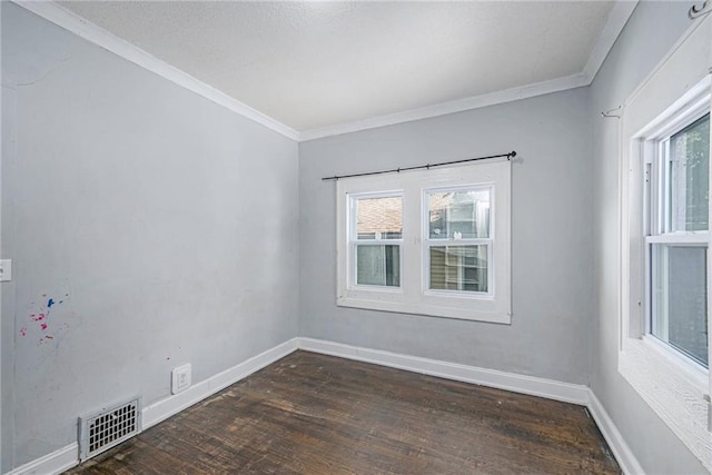1409 N 24th St, Kansas City, KS 66102 - empty room featuring healthy amount of natural light, crown molding, wood finished floors, and baseboards