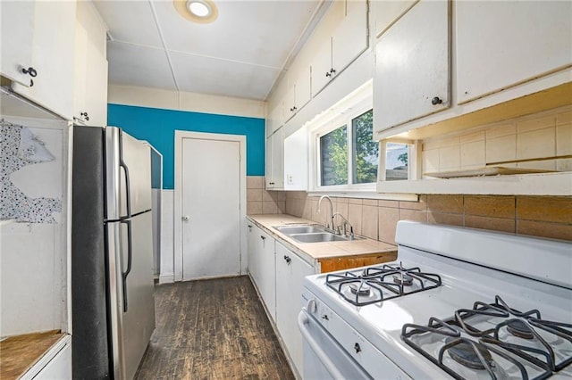 1409 N 24th St, Kansas City, KS 66102 - kitchen featuring gas range gas stove, freestanding refrigerator, tile counters, a sink, and white cabinets