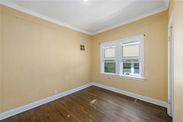 1409 N 24th St, Kansas City, KS 66102 - spare room with dark wood-style floors, baseboards, and ornamental molding