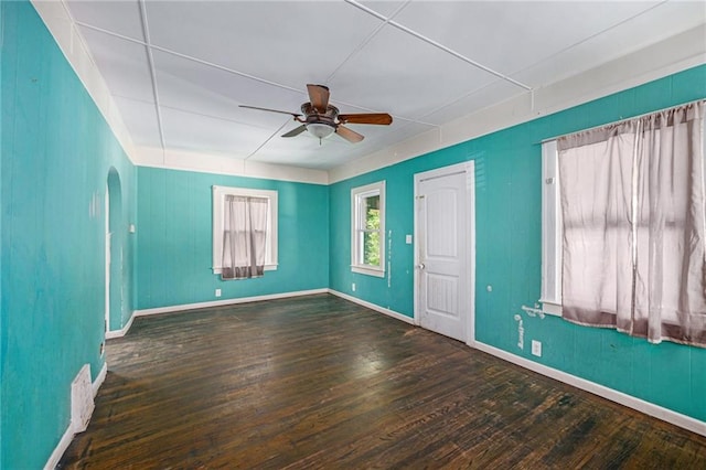 1409 N 24th St, Kansas City, KS 66102 - spare room featuring ceiling fan, hardwood / wood-style flooring, arched walkways, and baseboards