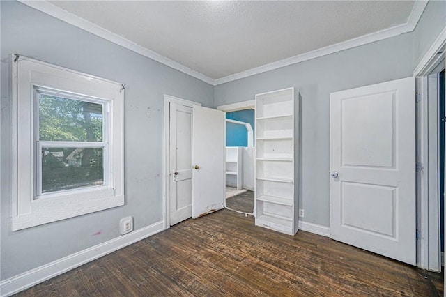 1409 N 24th St, Kansas City, KS 66102 - unfurnished bedroom featuring crown molding, dark wood-type flooring, and baseboards
