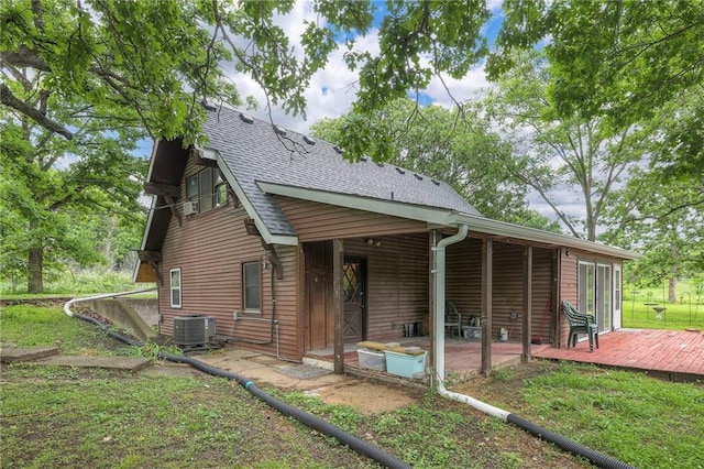 25801 E 317th Ter, Harrisonville, MO 64701 - rear view of house with cooling unit, a wooden deck, a shingled roof, and a lawn