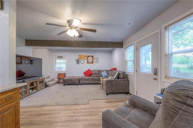 25801 E 317th Ter, Harrisonville, MO 64701 - living room with light wood finished floors, ceiling fan, a textured ceiling, and beamed ceiling