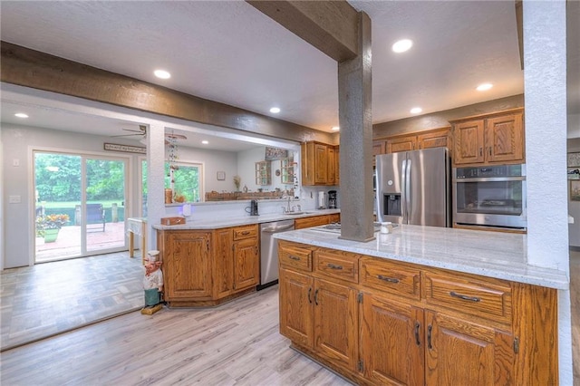 25801 E 317th Ter, Harrisonville, MO 64701 - kitchen featuring stainless steel appliances, brown cabinetry, light wood-style floors, recessed lighting, and a sink