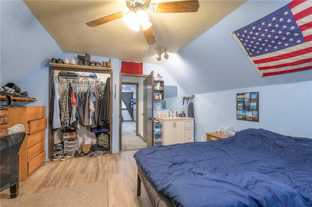 25801 E 317th Ter, Harrisonville, MO 64701 - bedroom with wood finished floors, vaulted ceiling, a textured ceiling, a closet, and ceiling fan