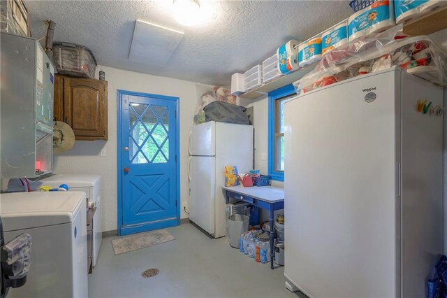 25801 E 317th Ter, Harrisonville, MO 64701 - washroom with a textured ceiling, washer and clothes dryer, cabinet space, and attic access