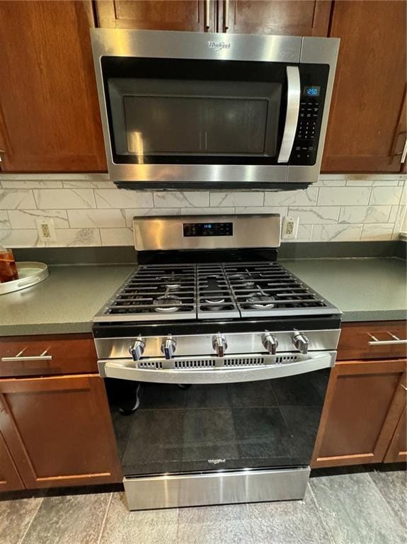 600 E 8th St Unit 6N, Kansas City, MO 64106 - kitchen view of stainless steel appliances, decorative backsplash, and brown cabinets