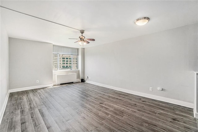 600 E 8th St Unit 6N, Kansas City, MO 64106 - spare room featuring a ceiling fan, baseboards, wood finished floors, and radiator