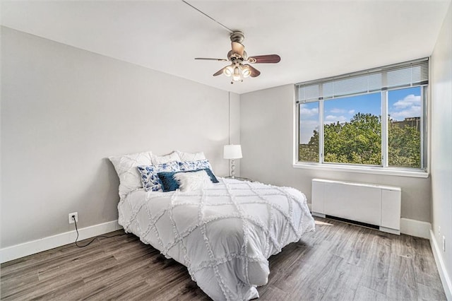 600 E 8th St Unit 6N, Kansas City, MO 64106 - bedroom with radiator heating unit, baseboards, and wood finished floors