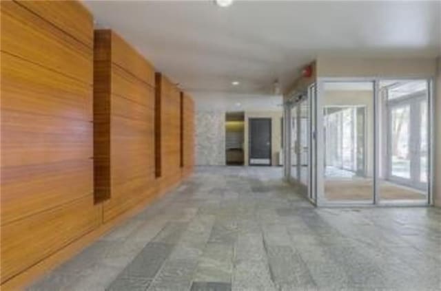 600 E 8th St Unit 6N, Kansas City, MO 64106 - hallway featuring wood walls